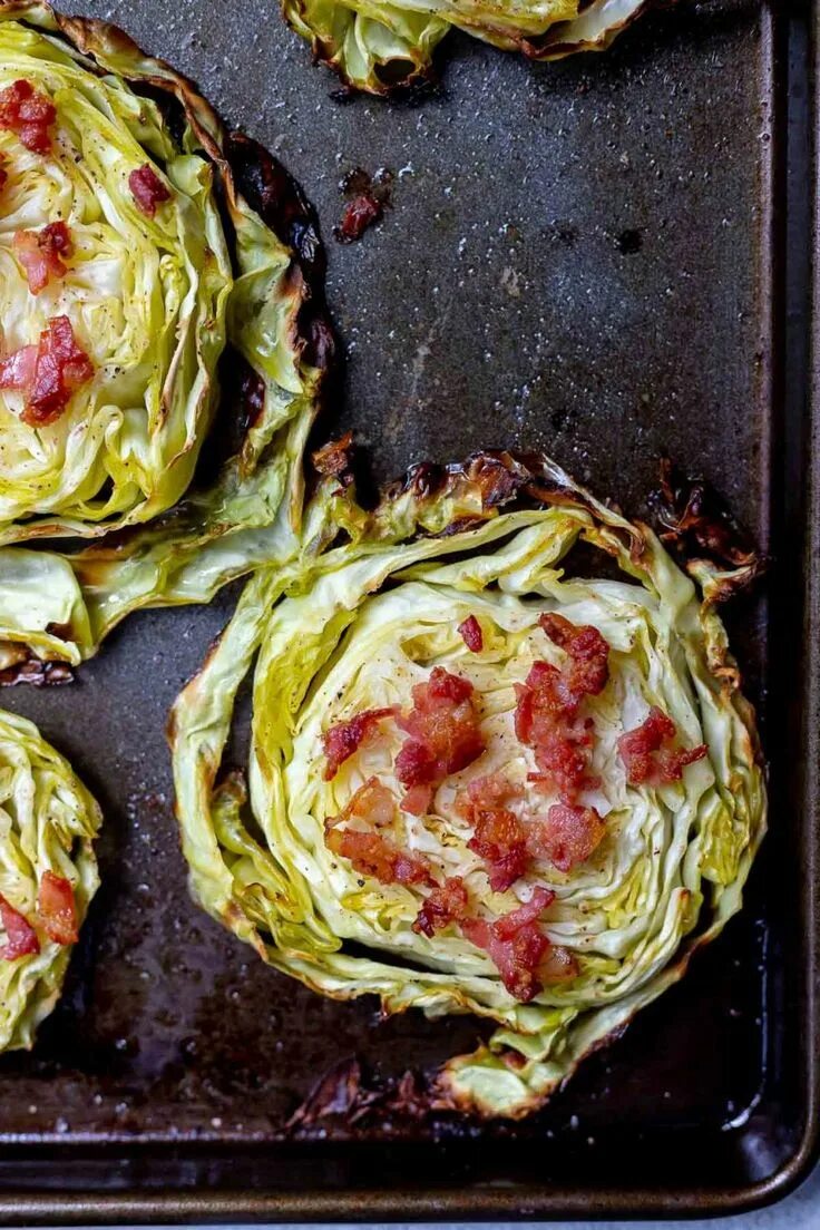 Капустные стейки в духовке рецепт с фото roasted cabbage steak topped with bacon on a dark baking sheet in 2020 Cabbage s
