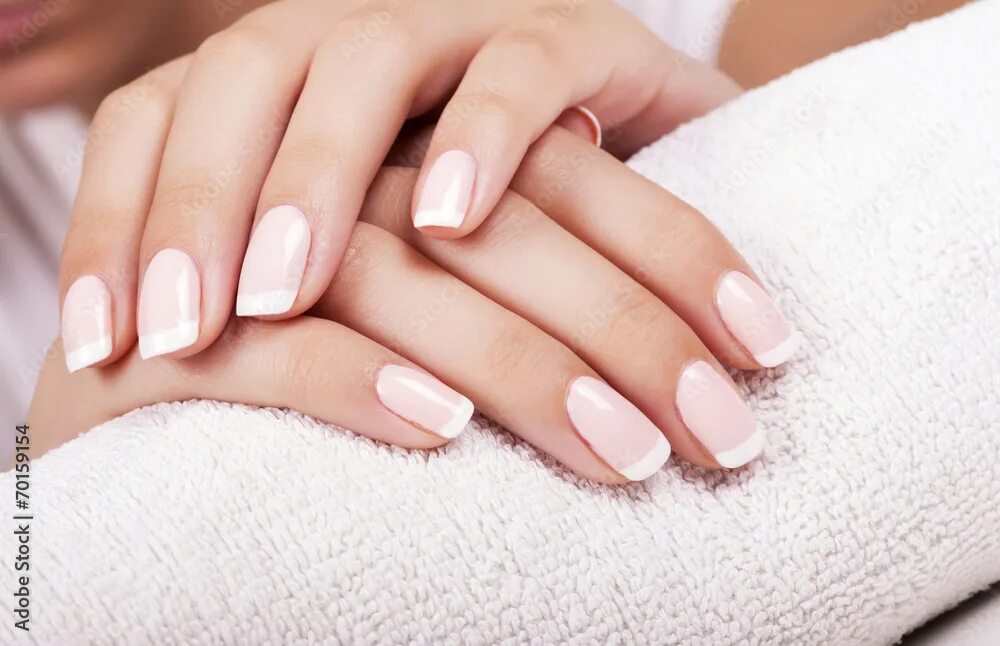 Красивый аккуратный маникюр Beautiful woman's nails with french manicure. Фотографія Stock Adobe Stock