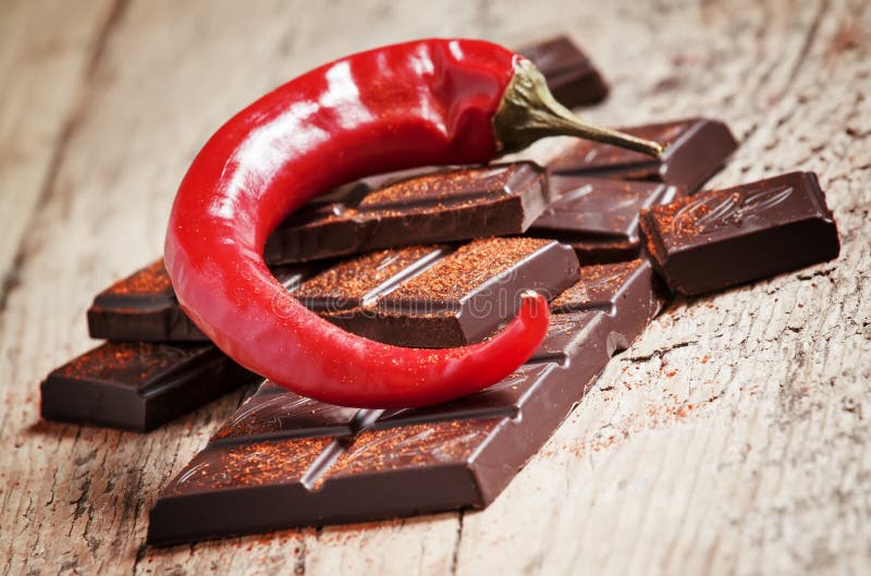 Красный шоколад фото Chopped Dark Chocolate, Red Chili Pepper and Red Pepper, Selective Focus Stock P