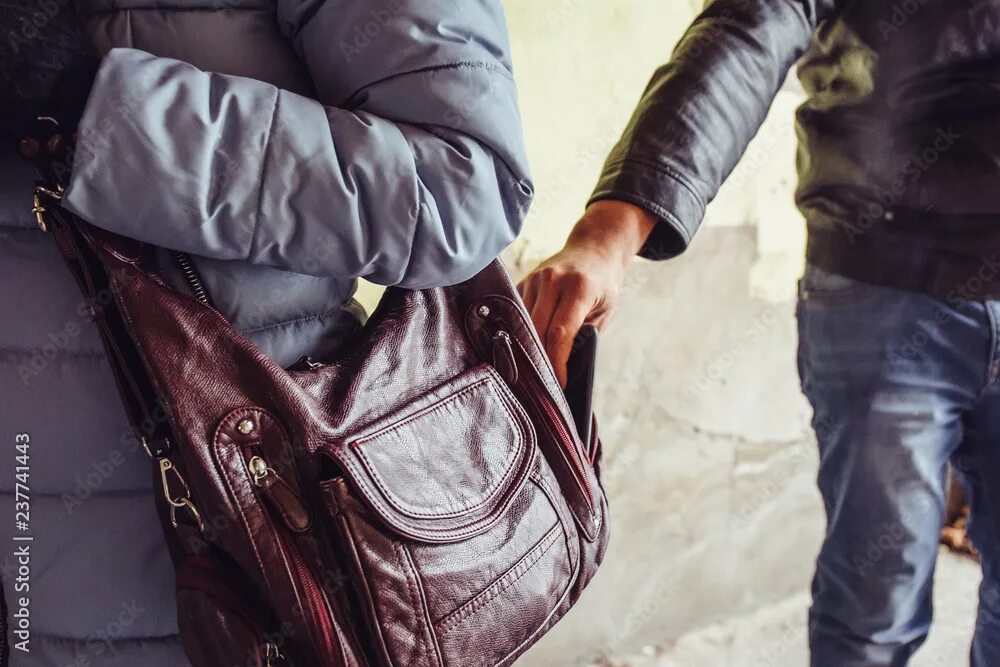 Кража сумочки Thief steals phone or smartphone from bag of woman close up, pickpocket in city 