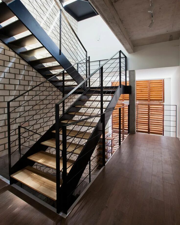 Лестница в стиле лофт в частном доме narrow townhouse in vietnam by MM++ features a retractable shutter screen Stairs