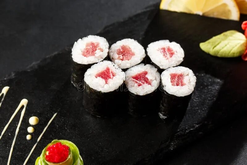 Маки суши фото Maki Sushi Rolls with Tuna on Black Stone on Dark Background. Sushi Menu. Japane
