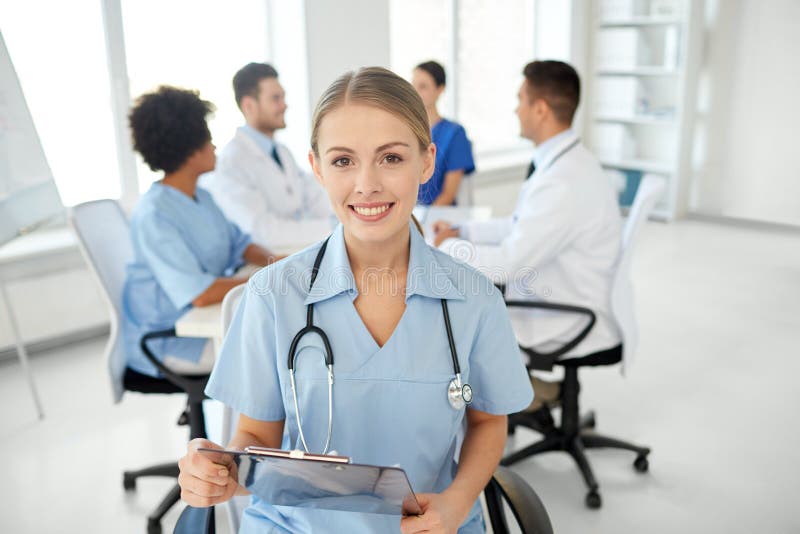 Медицинские работники картинки Happy Doctor with Clipboard Over Group of Medics Stock Image - Image of arfican,