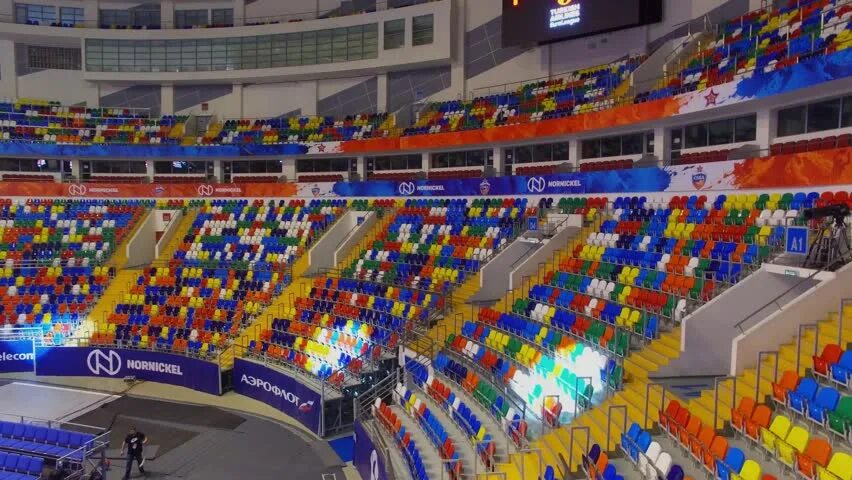 Мегаспорт арена фото с секторами MOSCOW - APR 07, 2017: Projector spots move by tribunes with colorful chairs in 