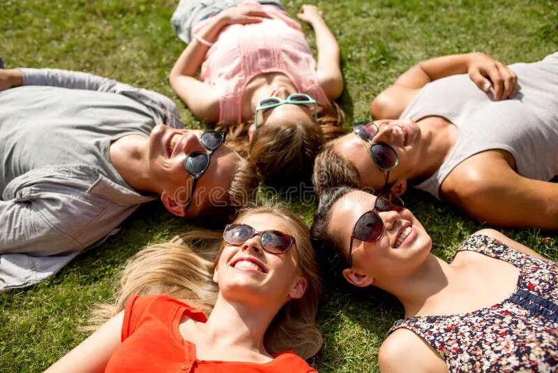 Много хороших фото Group of Smiling Friends Lying on Grass Outdoors Stock Image - Image of nice, jo