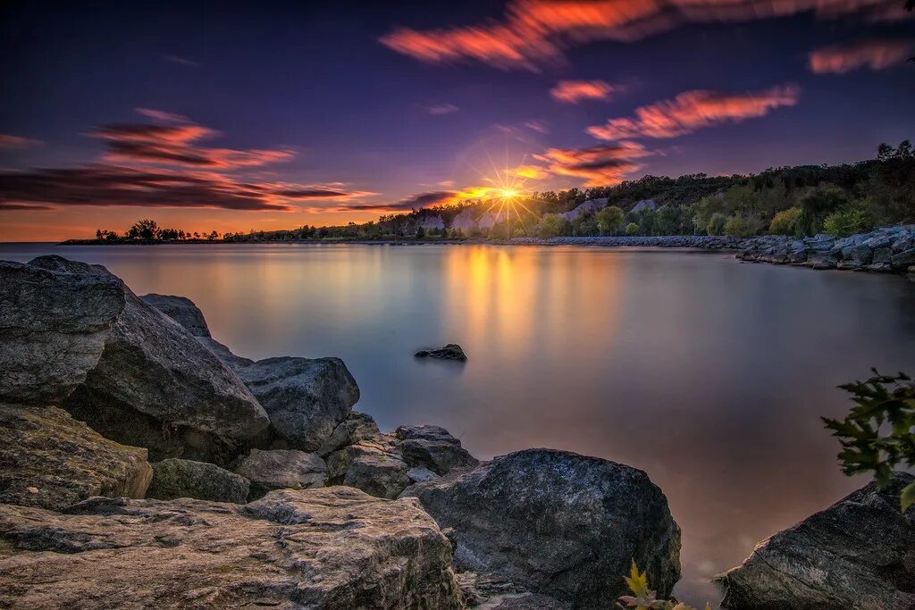 Озеро онтарио фото Rocky Sunflare Long exposure image of the sun setting behi. Flickr