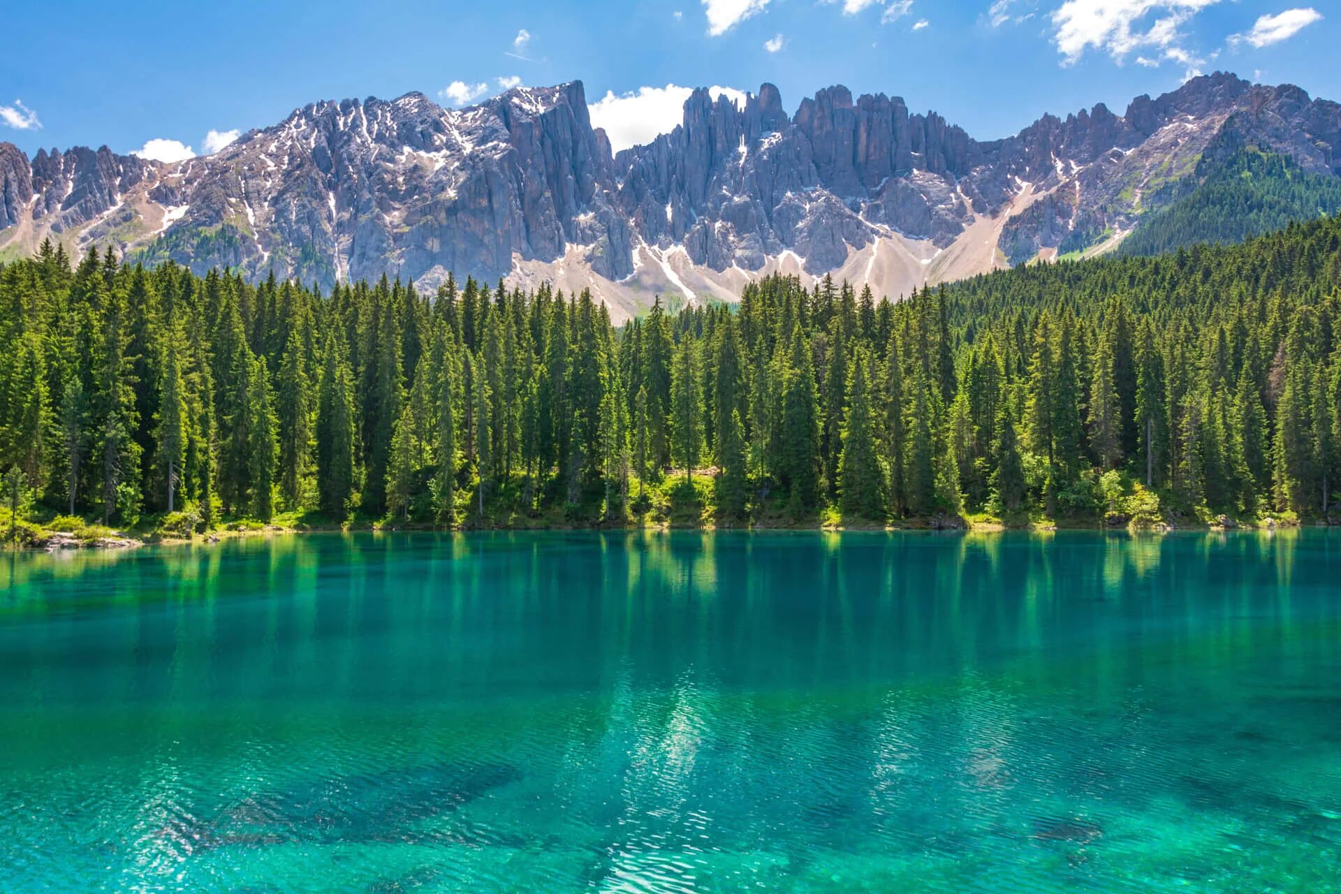 Озеро в горах фото Download A Lake Surrounded By Trees And Mountains Wallpapers.com