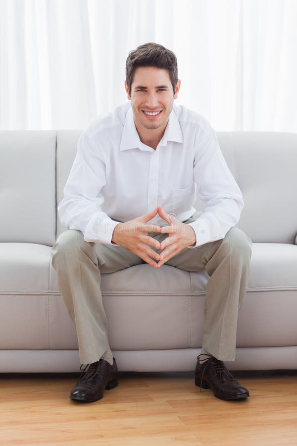 Парень сидит на диване фото Young man sitting on sofa stock image. Image of adult - 33053017