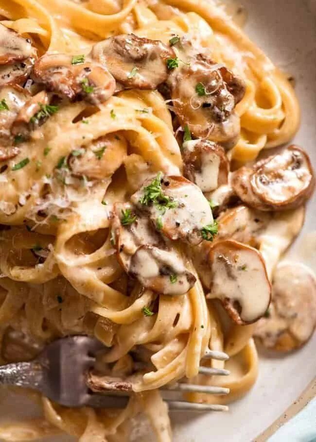 Паста с свининой рецепт с фото Close ups of Creamy Mushroom Pasta on a rustic handmade plate, ready to be eaten