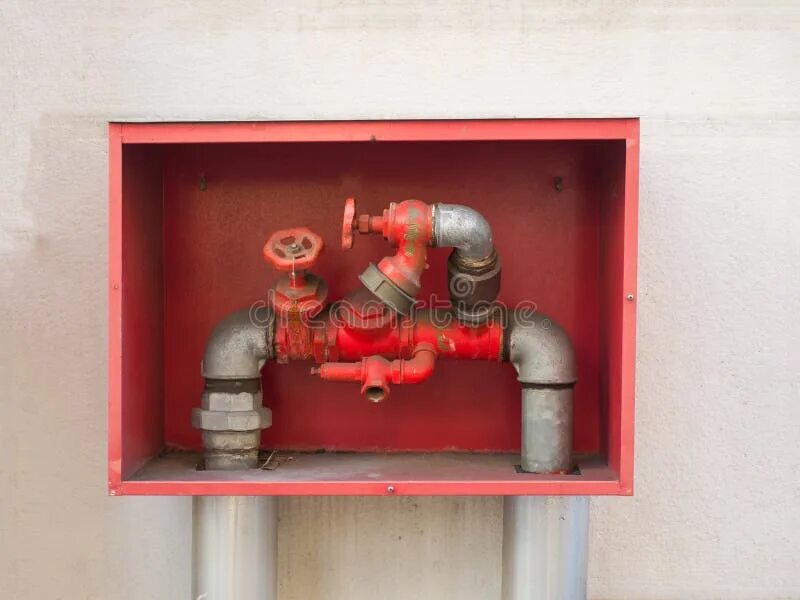 Патрубки для подключения пожарных машин Building`s Fire Hose Connections with Red Handles in a Red Box Stock Image - Ima