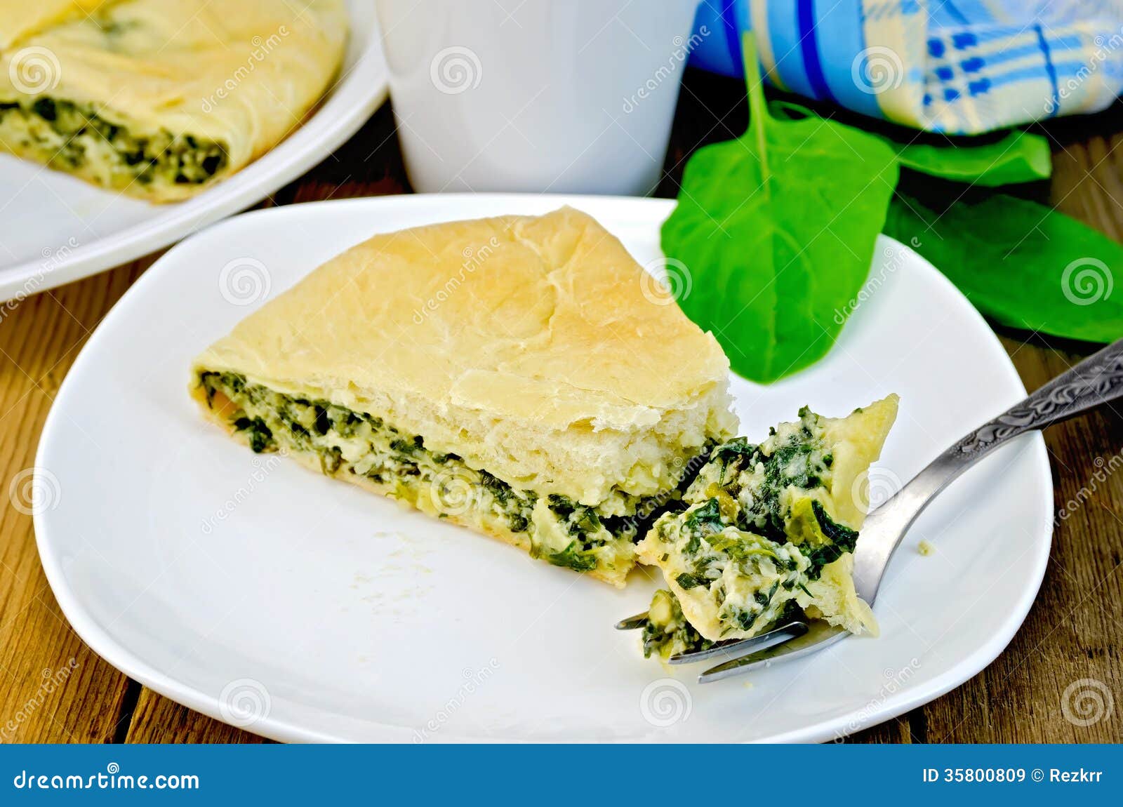 Пирог со шпинатом и сыром фото Pie with Spinach and Cheese with a Fork on a Board Stock Image - Image of backgr