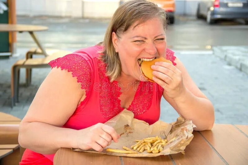 Пироги толстушки фото Thick Woman Eating Fast Food Hamburger and French Fries in a Cafe at a Table on 