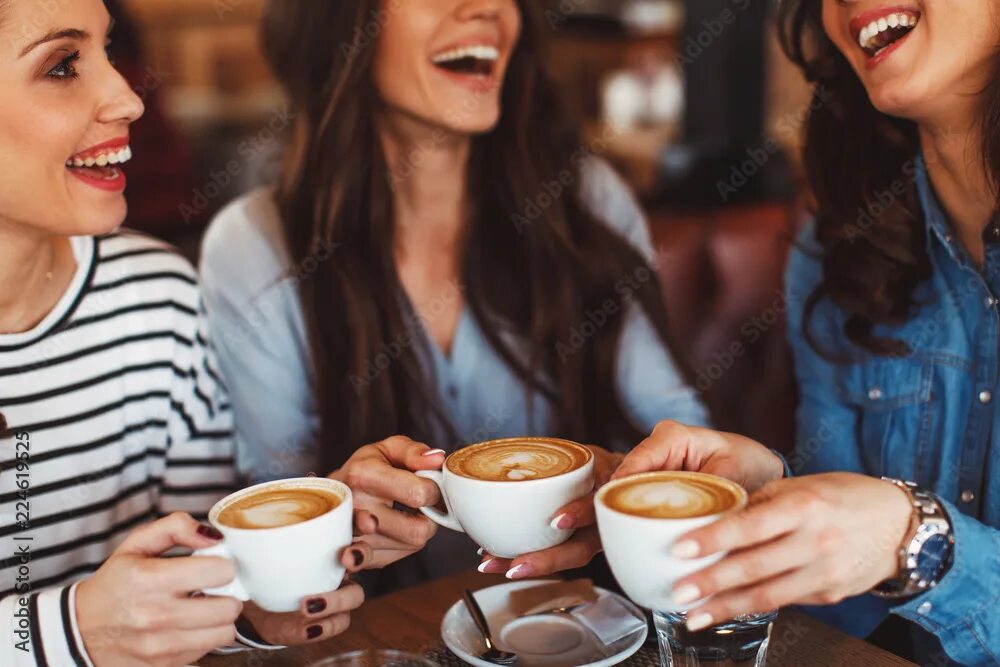 Пить кофе фото Three young women enjoy coffee at a coffee shop Фотографія Stock Adobe Stock