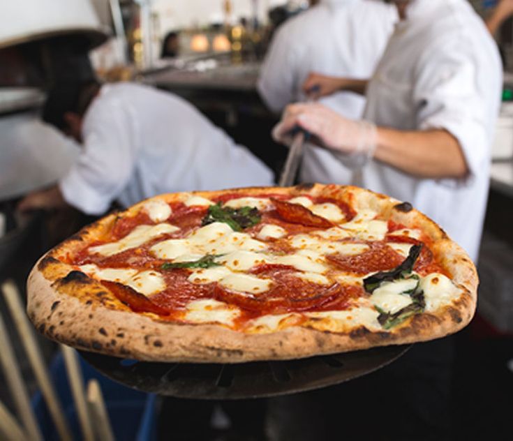 Пицца в кафе фото MidiCi Neapolitan pizza brings friends together in a warm, upbeat atmosphere. Si