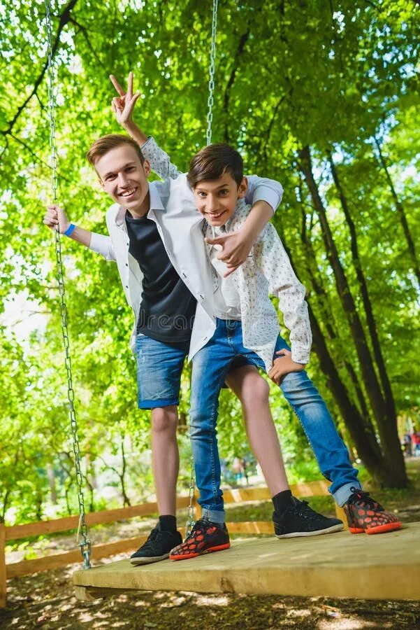 Подростки летнее фото Smiling Boys Having Fun at Playground. Children Playing Outdoors in Summer. Teen