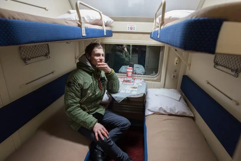 Поезд андрей тульников фото A Passenger of a Young Man Sitting in a Train Compartment Editorial Image - Imag