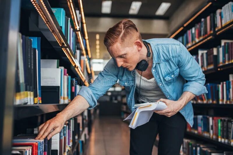 Поиск книги по фото Student Looking for a Book in Shelf Stock Image - Image of library, handsome: 79