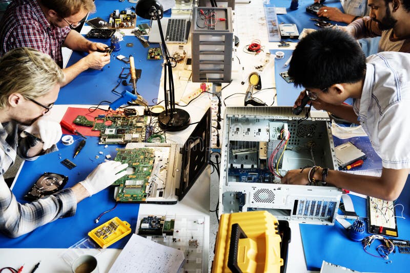 Поиск техники по фото Electronics Technicians Team Working on Computer Parts Stock Photo - Image of oc