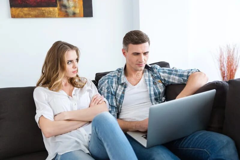 Пока муж на работе фото Unhappy Woman Sitting while Her Husband Working with Laptop Stock Photo - Image 