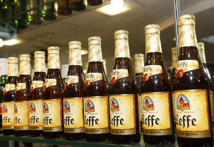 Поля лефф фото Leffe beer bottles at the bar. Leffe beer bottles are displayed inside a superma