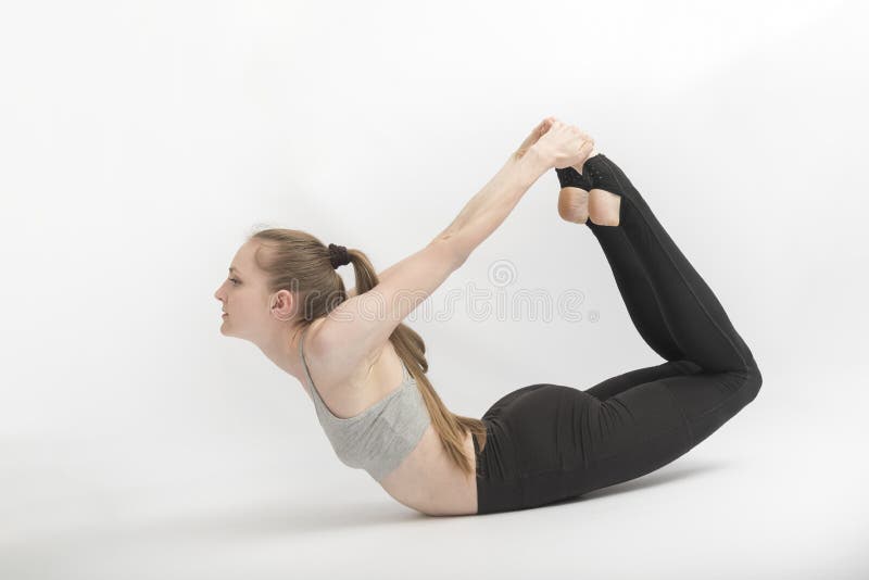 Поза лука фото Bow Pose. Dhanurasana. a Young Woman Performs Asana on White Background. the Gir