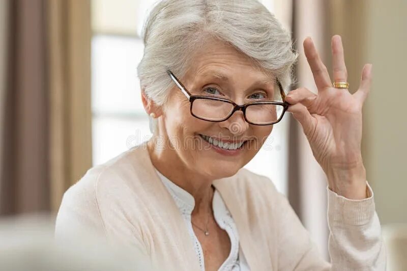 Пожилая женщина в очках фото Holding Eyeglasses Looking through Lenses Stock Image - Image of formal, busines