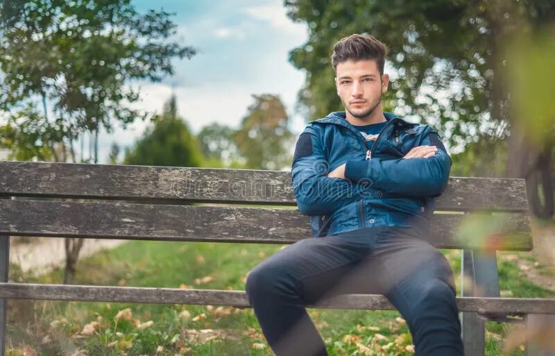 Позитивные парни картинки Young Man in Jacket Sitting on Bench in the Park. One Beautiful Guy Stock Image 