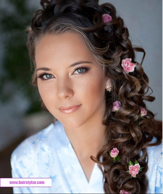 Прически для девушек на праздник фото Beautiful long loose flowing curls and flowers inserted for a pretty soft romant