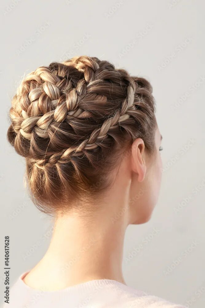 Прически заплетенные фото Young beautiful woman with nice braid hairstyle on light background фотография S