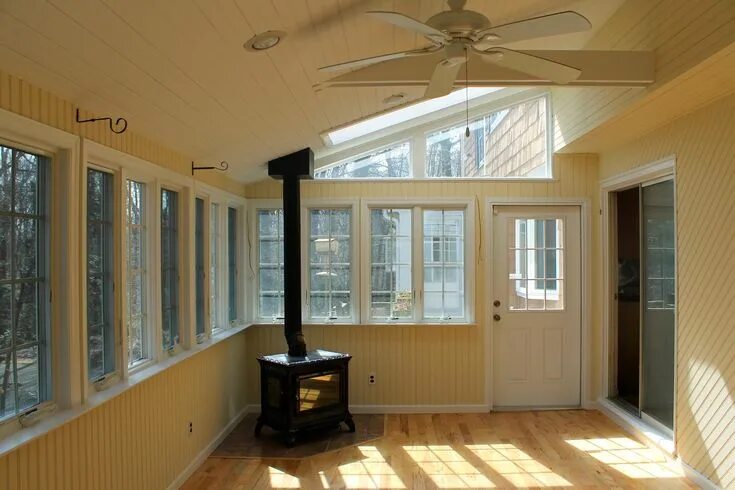 Прихожая веранда фото beautiful sunroom with a working wood burning stove that produces enough heat fo