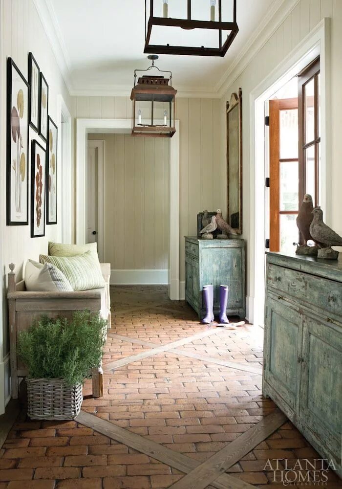 Прихожая загородного дома фото Atlanta Homes Magazine mudroom with plank walls, brick floor, french doors and l