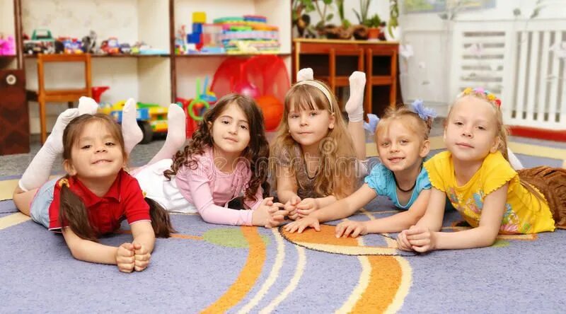 Примеры фото в детском саду Group of children in a kindergarten. Group of smiled children in a kindergarten 