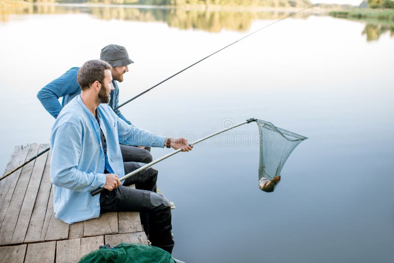 Приснилось что ловлю рыбу на удочку Men Catching Fish on the Lake Stock Photo - Image of male, caucasian: 121185086