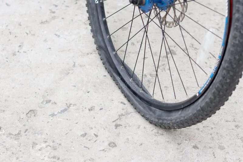 Пробитое колесо велосипеда фото Bicycle Wheel with Flat Tyre on the Concrete Road. Stock Image - Image of black,