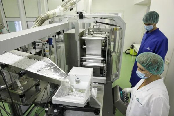 Hand Holding Blue Capsule Pack at Medicine Pill Production Line Stock Image - Im