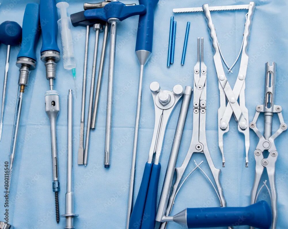 Проктологические инструменты фото и названия Sterilized surgical instruments and tools on the blue table. A spine surgery equ