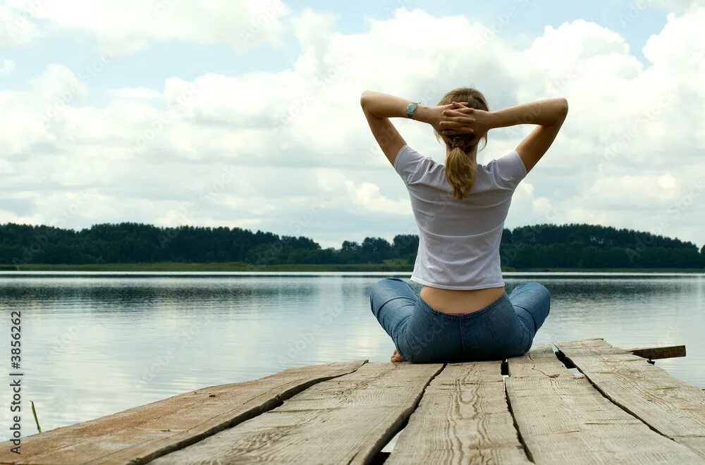 Психическое здоровье человека фото The girl is engaged in meditation on coast of lake фотография Stock Adobe Stock