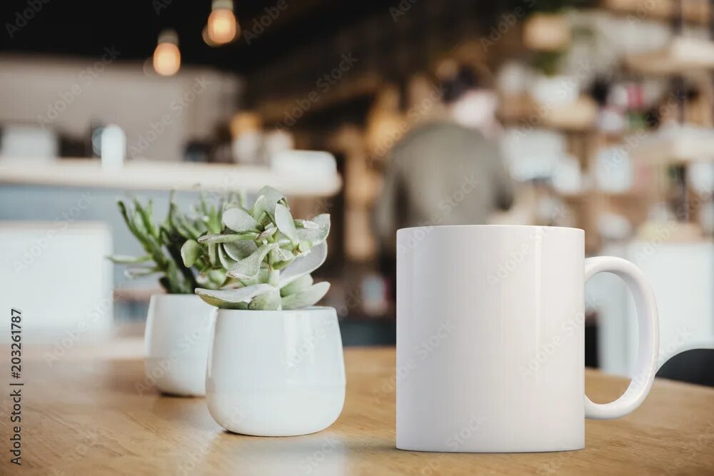 Работа кружка фото White coffee Mug Mockup set-up in a cafe, next to cactus plants and with blurred