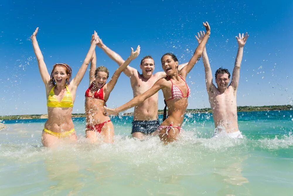 Group of people freelancers using laptop computer sitting near swimming pool and