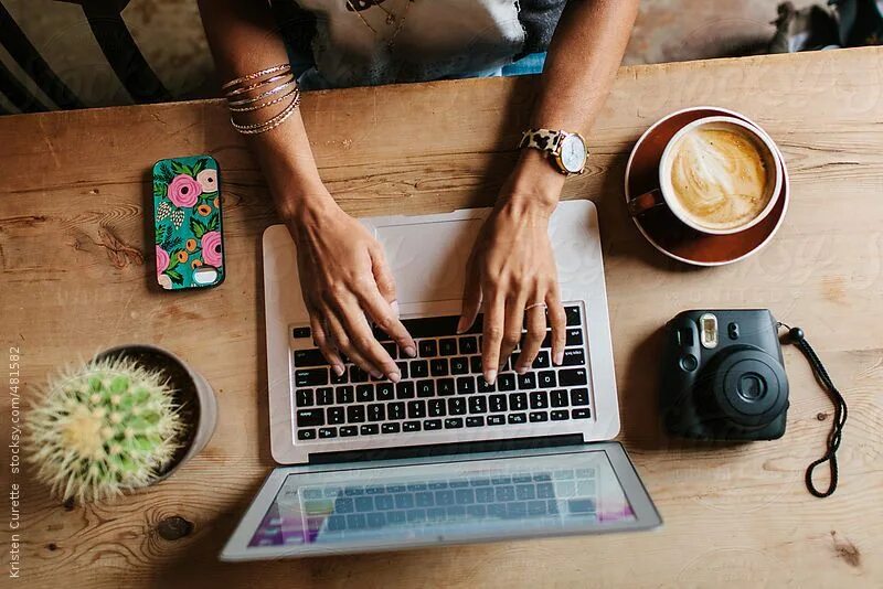 Работа мечты фото Woman sitting at a coffee shop working on a laptop & drinking a latte. by Kriste