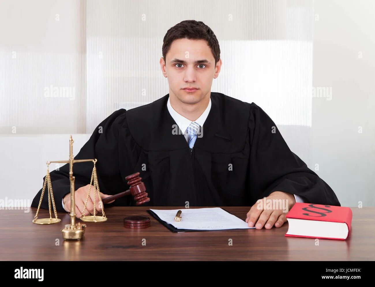 Работа судьи фото Portrait of confident male judge sitting at table in courtroom Stock Photo - Ala