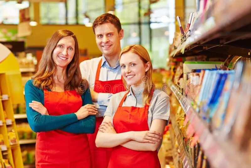 Работник магазина фото Smiling Sales Team Staff in Supermarket Stock Image - Image of people, employee: