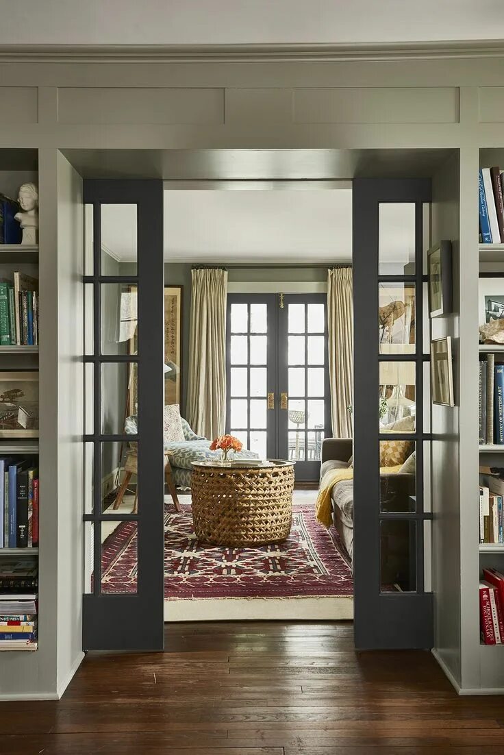 Раздвижные двери в интерьере гостиной New French doors invite daylight to flow through the den and the living room whi