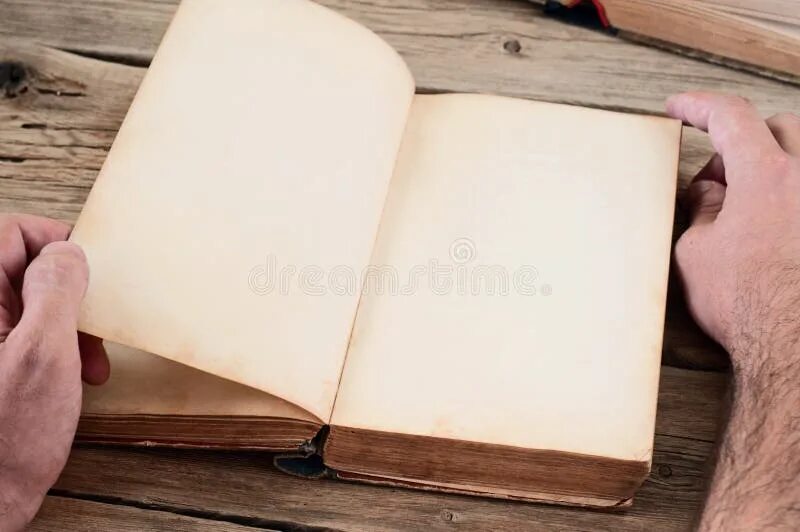 Развернутый книга фото Men Turns the Page of the Book on the Wooden Table Stock Photo - Image of resear