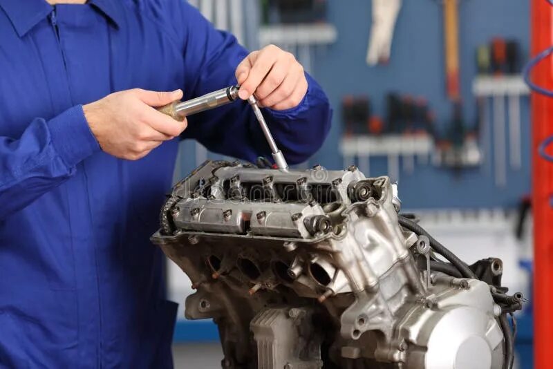 Ремонт двс своими руками Motorcycle Mechanic Repairing an Engine Stock Photo - Image of disassembling, da