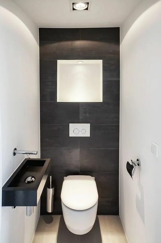 Ремонт маленького туалета варианты a minimalist guest bathroom with black and white tiles of different sizes, a bla